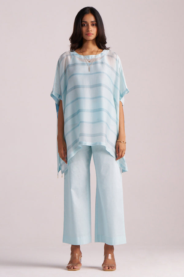 Woman wearing a Misty Blue Silk Kaftaan Co-ord Set on a plain background