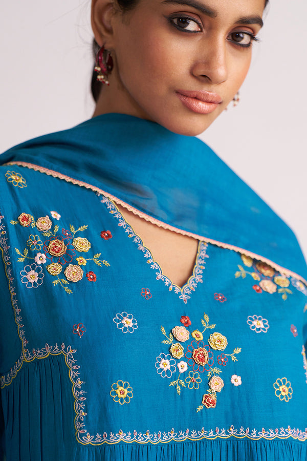 Woman wearing a Celestial Blue Embroidered Kurta Set with a plain background