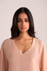 Woman wearing a Spanish Villa Silk Kaftaan Co-ord Set against a plain background