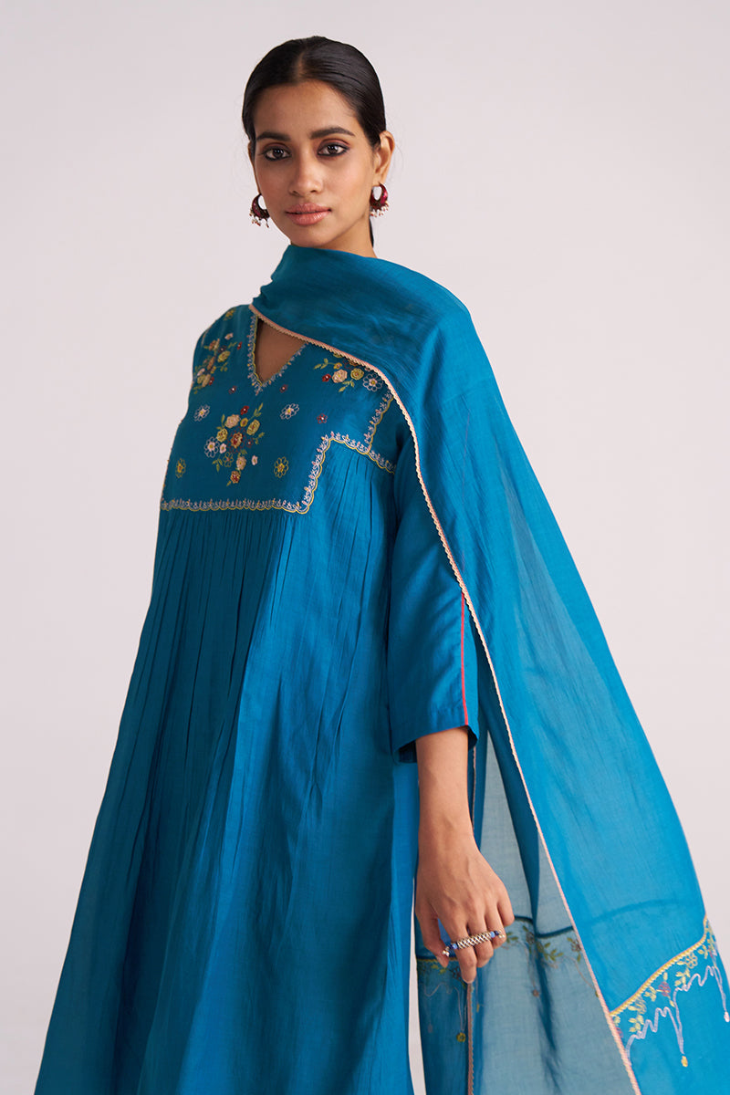 Woman wearing a Celestial Blue Embroidered Kurta Set with intricate designs on a plain background