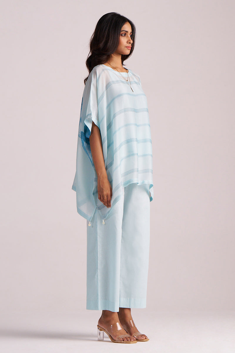 Woman wearing a Misty Blue Silk Kaftaan Co-ord Set on a plain background