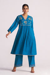 Woman wearing a Celestial Blue Embroidered Kurta Set outfit on a white background