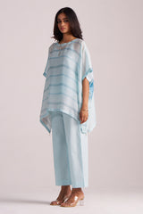 Woman wearing a Misty Blue Silk Kaftaan Co-ord Set on a plain background