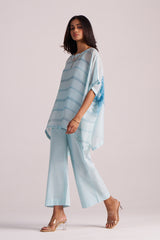 Woman wearing a Misty Blue Silk Kaftaan Co-ord Set on a plain background