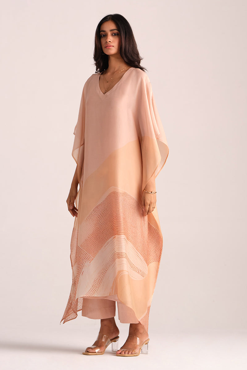 Woman wearing a Spanish Villa Silk Kaftaan Co-ord Set on a plain background