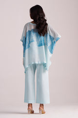 Woman wearing a Misty Blue Silk Kaftaan Co-ord Set on a plain background