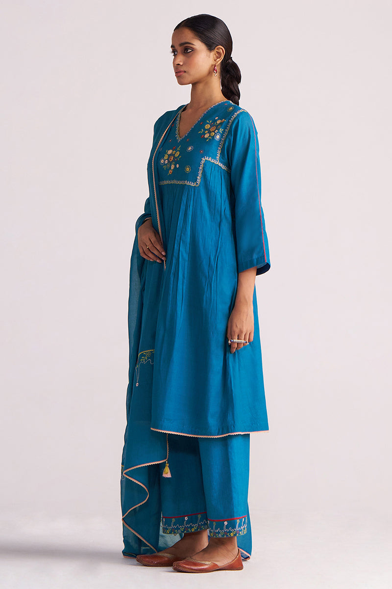 Woman wearing a Celestial Blue Embroidered Kurta Set outfit on a light gray background