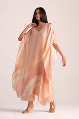Woman wearing a Spanish Villa Silk Kaftaan Co-ord Set on a plain background