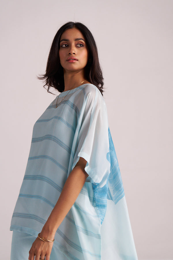 Woman wearing a Misty Blue Silk Kaftaan Co-ord Set against a plain background