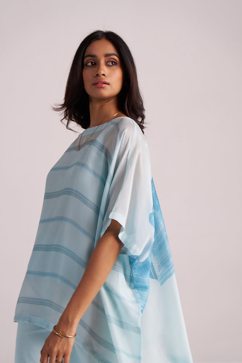 Woman wearing a Misty Blue Silk Kaftaan Co-ord Set against a plain background