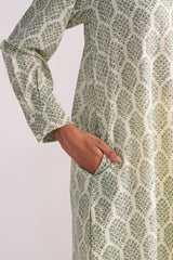 Cream and Deep Olive Mughal Tree Hand Print Cotton-Linen Co-ord Set with a hand in the pocket on a light gray background