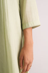 Quient Green Mul-Mul Co-ord Set a hand holding it against a light background