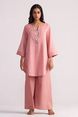 Woman wearing a Rose Tan Mul-Mul Co-ord Set on a light pink background