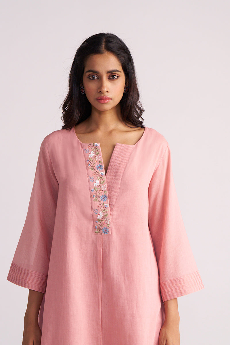 Woman wearing a Rose Tan Mul-Mul Co-ord Set with floral embroidery on a light pink background
