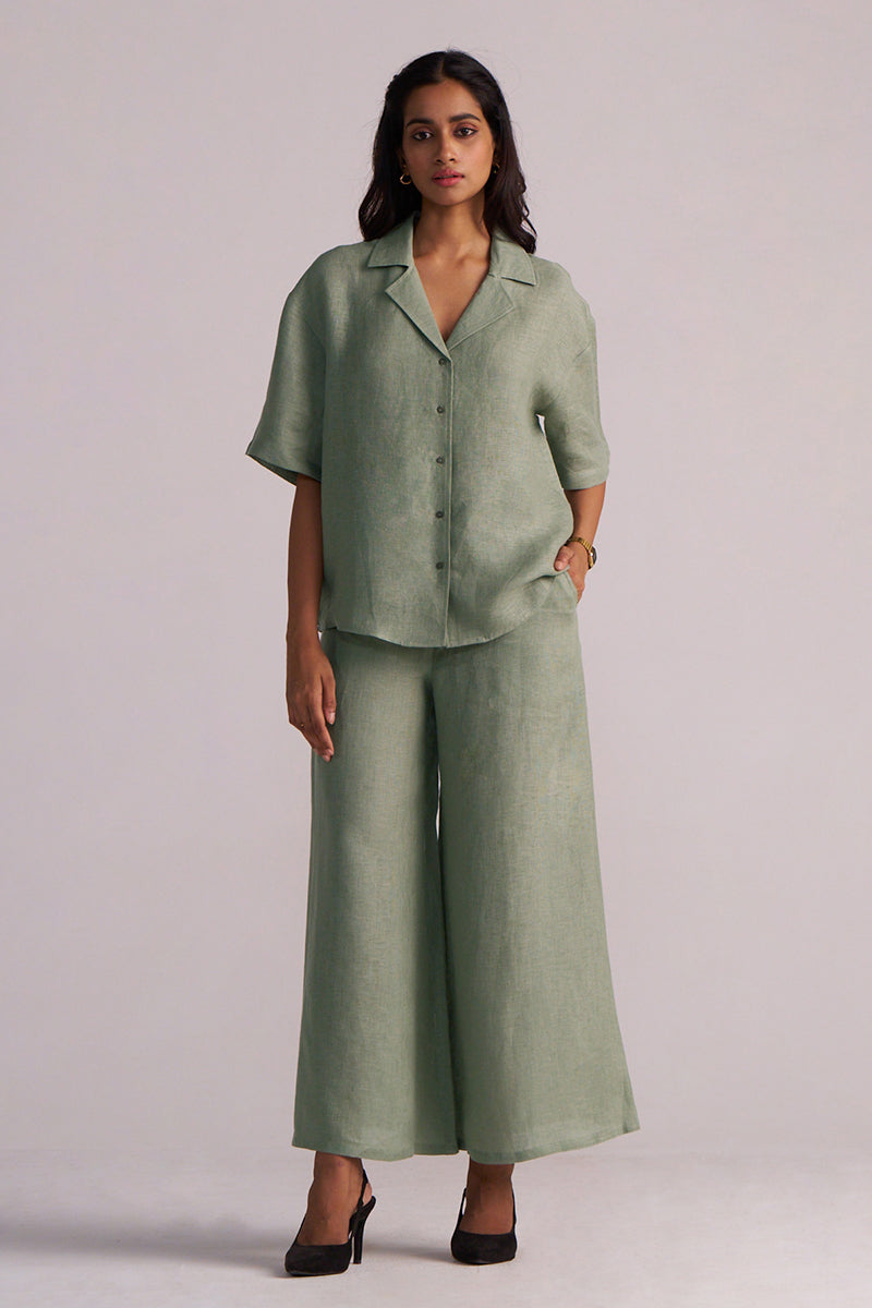 Woman wearing a Lily Pad Green Pure Linen Co-ord Set with a plain background