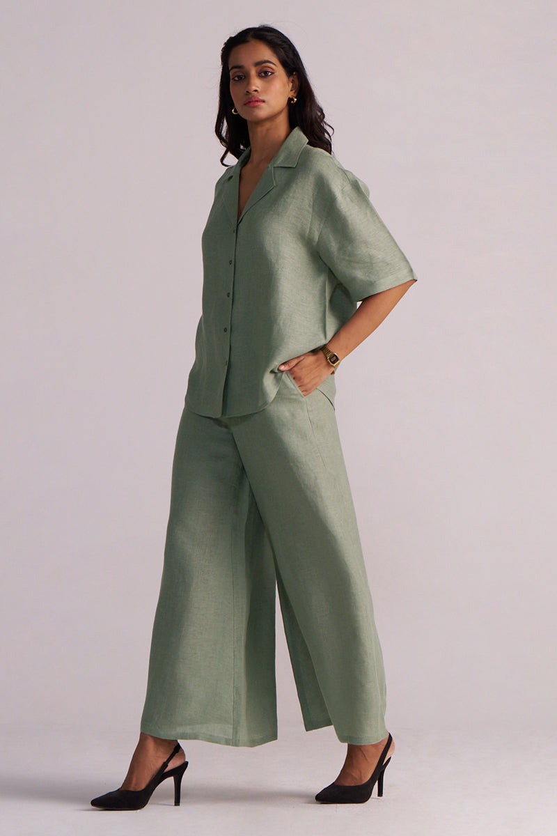 Woman wearing a Lily Pad Green Pure Linen Co-ord Set on a plain background