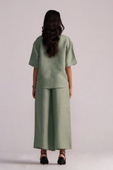 Person wearing a Lily Pad Green Pure Linen Co-ord Set on a plain background