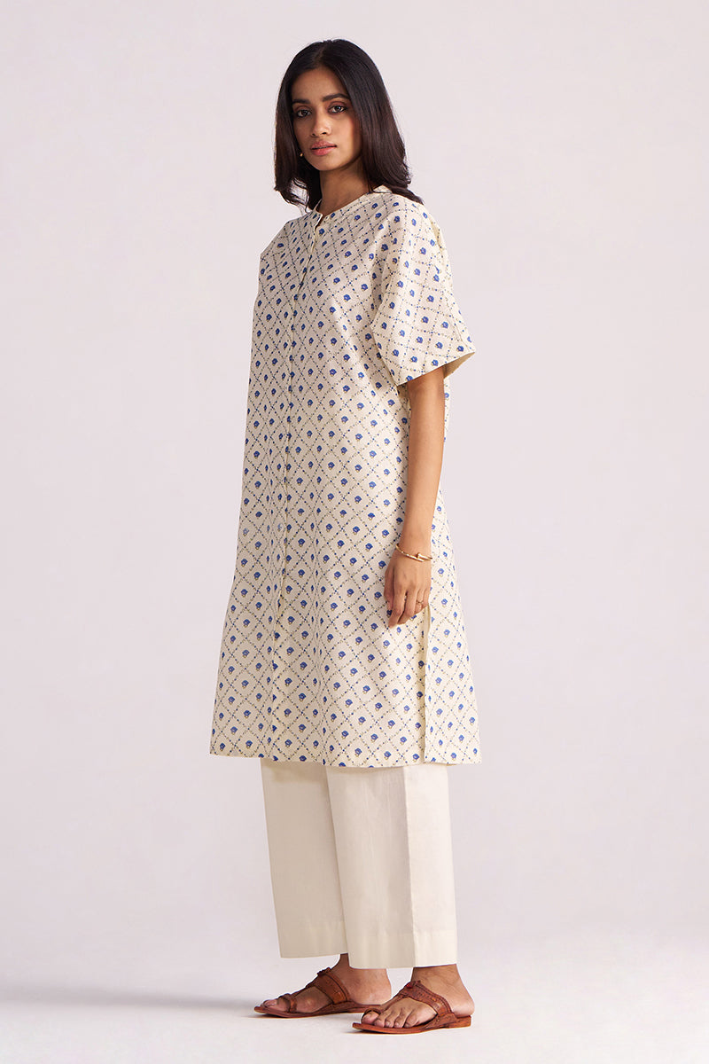 Woman wearing a Cream and Blue Small Flower Hand-Print Cotton Linen Co-ord Set on a light gray background