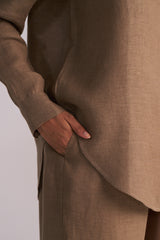 Woodsmoke Brown Pure Linen Co-ord Set with a hand in the pocket on a light gray background